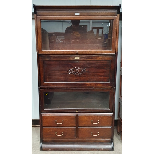 650 - An oak and glazed Globe Wernicke style Barrister's Bookcase with glazed section above a fitted desk ... 