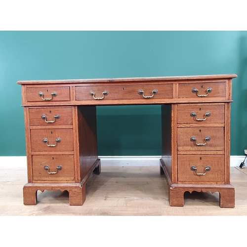 653 - An oak twin pedestal Desk fitted nine drawers 4ft W x 2ft 5in H