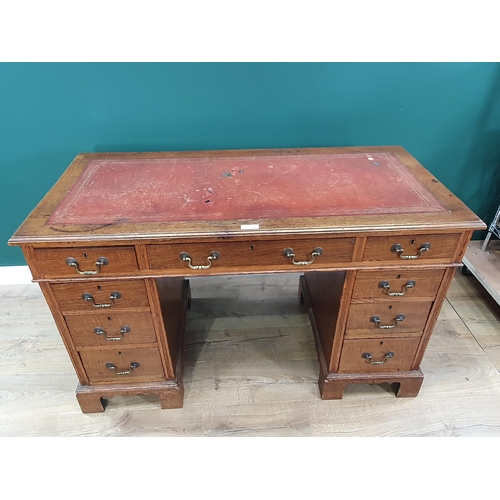 653 - An oak twin pedestal Desk fitted nine drawers 4ft W x 2ft 5in H