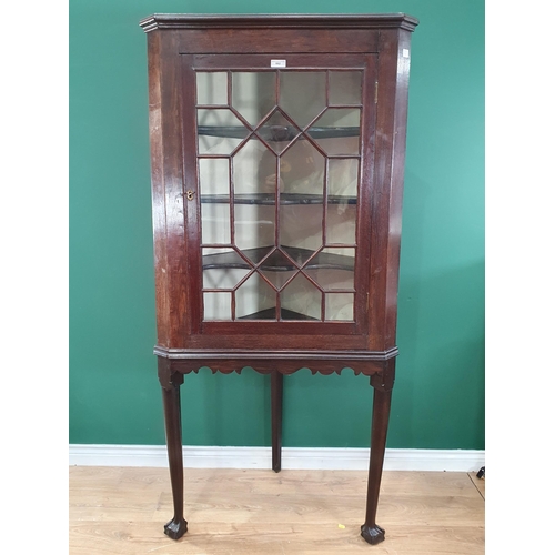 662 - An antique oak Corner Cupboard on Stand with single astragal glazed door enclosing shaped shelves, 6... 