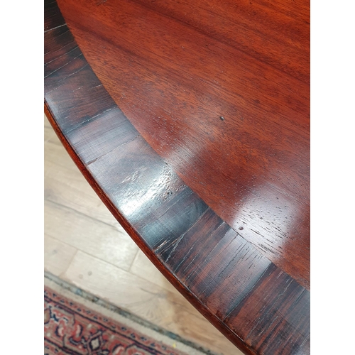 668 - A 19th Century mahogany and rosewood crossbanded circular Breakfast Table on turned column and out s... 