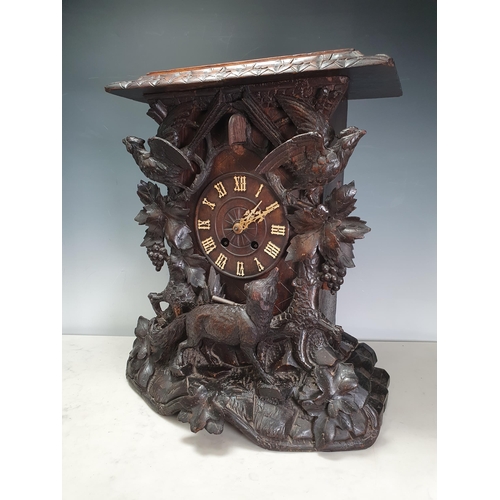 671 - A Black Forest oak Cuckoo Clock carved with fox and birds amongst vines 1ft 8in H x 1ft 4in W