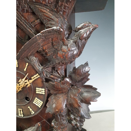 671 - A Black Forest oak Cuckoo Clock carved with fox and birds amongst vines 1ft 8in H x 1ft 4in W