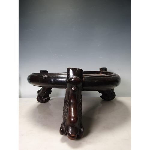 737 - A Chinese hardwood circular Stand on paw feet,  15in Diam