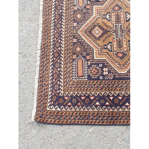 739 - A Persian Rug with multiple borders and three shaped medallions on a dark blue ground, 6ft 3in x 3ft... 