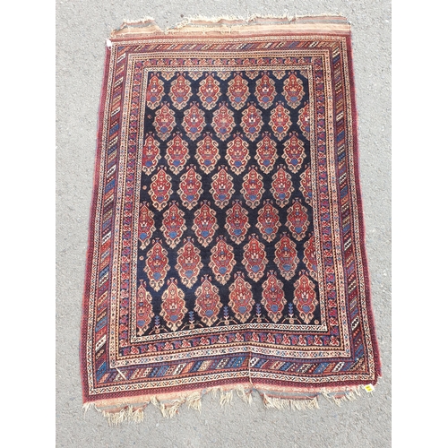 740 - A multi-bordered Persian Rug, the central ground with rows of shaped motifs on a blue ground, 7ft x ... 