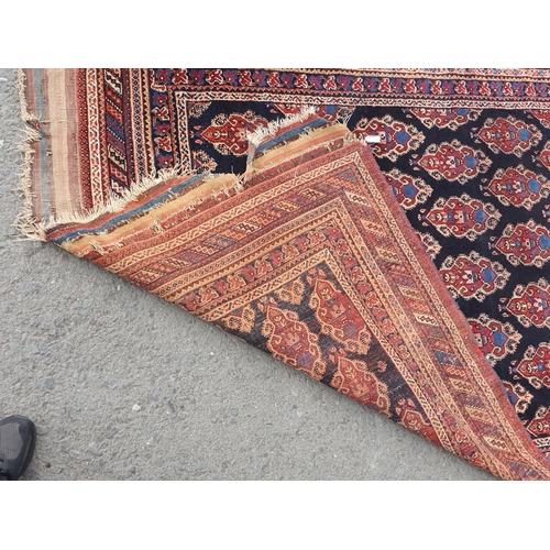 740 - A multi-bordered Persian Rug, the central ground with rows of shaped motifs on a blue ground, 7ft x ... 