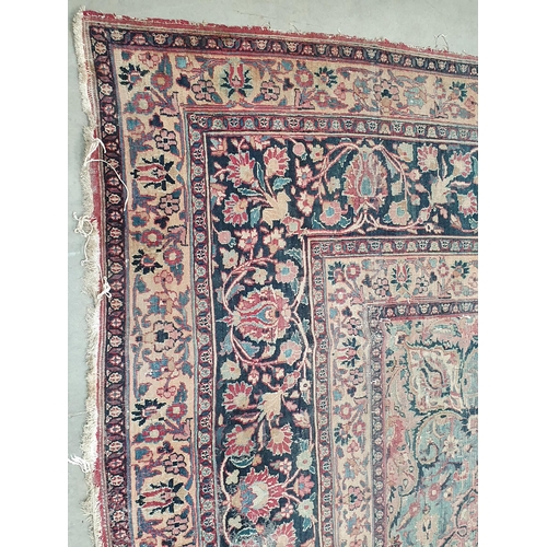 747 - A Persian Carpet of multi-bordered design, decorated scrolls and floral motifs on a blue and red gro... 