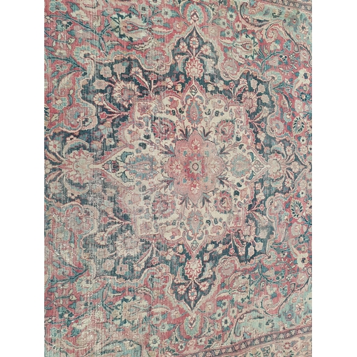 747 - A Persian Carpet of multi-bordered design, decorated scrolls and floral motifs on a blue and red gro... 