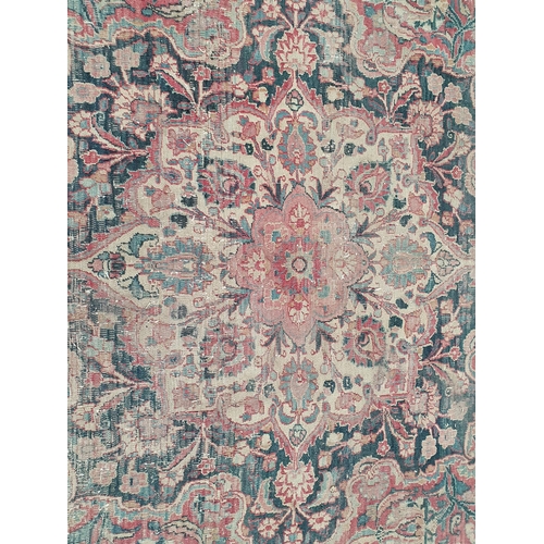 747 - A Persian Carpet of multi-bordered design, decorated scrolls and floral motifs on a blue and red gro... 