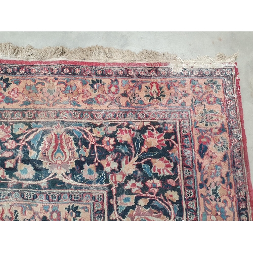 747 - A Persian Carpet of multi-bordered design, decorated scrolls and floral motifs on a blue and red gro... 