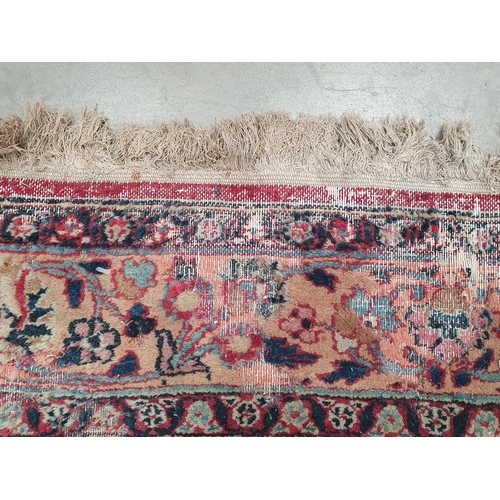 747 - A Persian Carpet of multi-bordered design, decorated scrolls and floral motifs on a blue and red gro... 