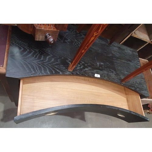 36 - A modern Black Ash veneered concave fronted Chest of three long Drawers.