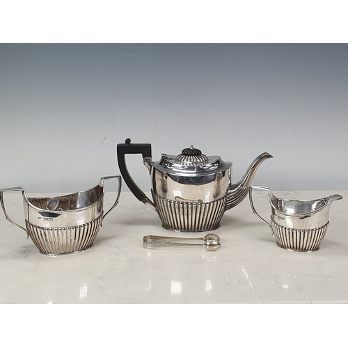 109 - An Edwardian silver three piece Tea Service of semi-lobed design and ebonised handle and finial to t... 