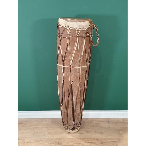 520 - A West African dug out trunk and skin covered Talking Drum 4ft 1in H