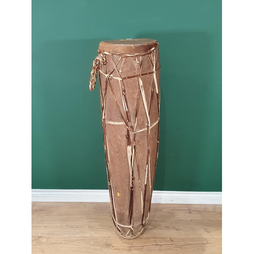 520 - A West African dug out trunk and skin covered Talking Drum 4ft 1in H