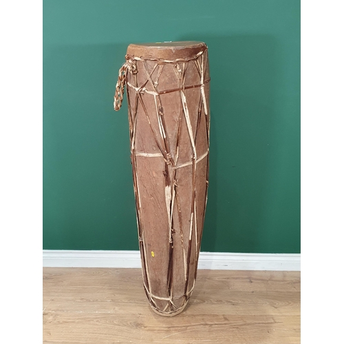 520 - A West African dug out trunk and skin covered Talking Drum 4ft 1in H