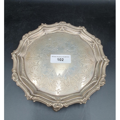 102 - A Victorian silver shaped circular small Salver with engraved frieze, scallop border on three shaped... 