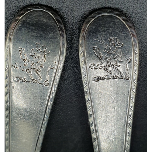 118 - A pair of George III silver Sauce Ladles old English pattern with feather edges and engraved crests,... 