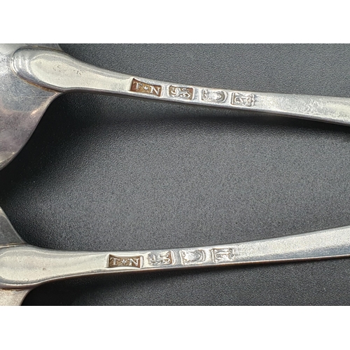 118 - A pair of George III silver Sauce Ladles old English pattern with feather edges and engraved crests,... 