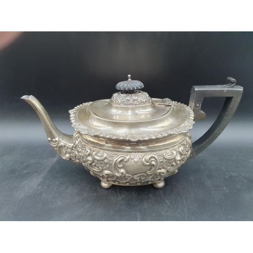 137 - An Edward VII silver four-piece Tea and Coffee Service with floral and scroll embossing on ball feet... 