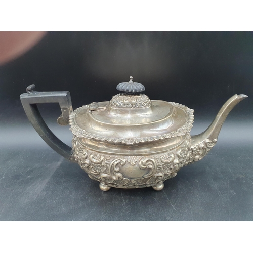 137 - An Edward VII silver four-piece Tea and Coffee Service with floral and scroll embossing on ball feet... 