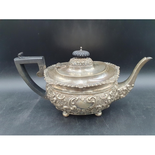 137 - An Edward VII silver four-piece Tea and Coffee Service with floral and scroll embossing on ball feet... 