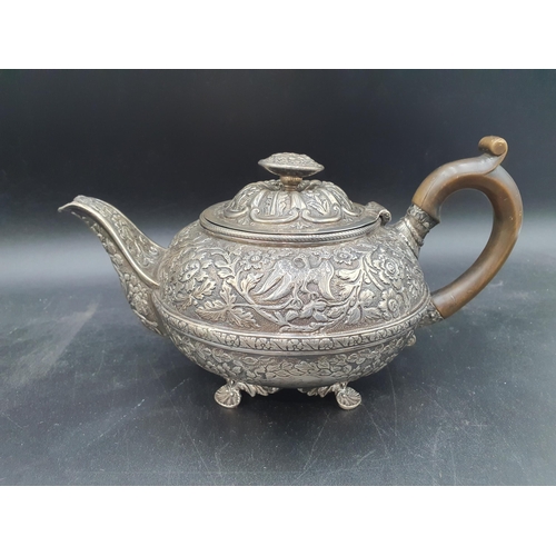 138 - A George III silver circular Teapot with bird, floral and leafage scroll embossing, engraved crest, ... 