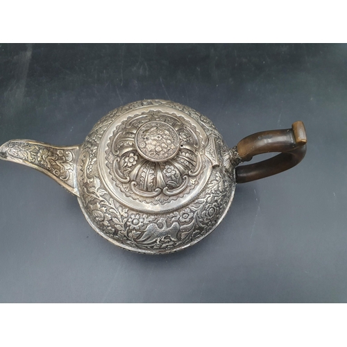 138 - A George III silver circular Teapot with bird, floral and leafage scroll embossing, engraved crest, ... 