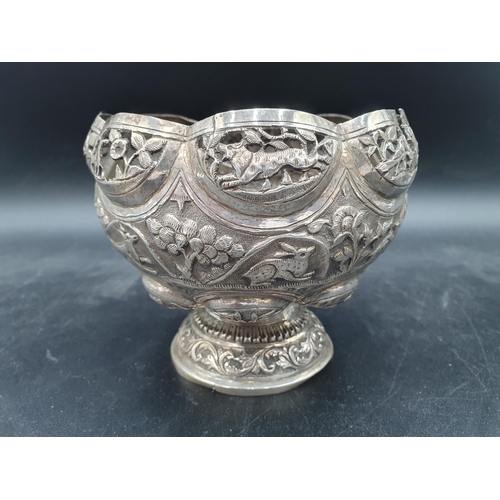 143 - An Indian silver Bowl embossed frieze of animals, 5in, and a white metal Pedestal Bowl with leafage ... 