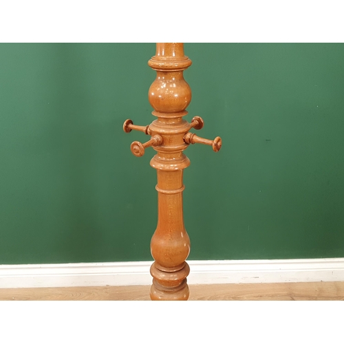 20 - A 19th Century turned Beech Coat/Hat Stand, the top with turned finial above six brass coat hooks, a... 