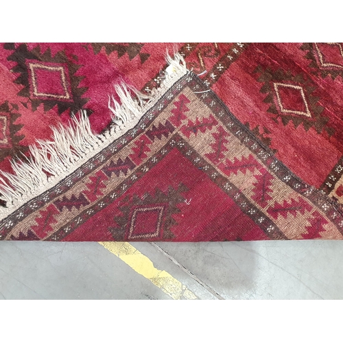 209 - A bordered Persian Rug, the central red ground with rows of lozenges, 5ft x 3ft 4in