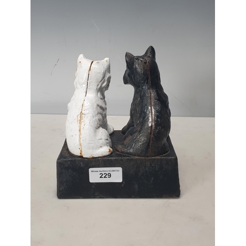 229 - A cast iron 'Black and White Scotch Whisky' Advertising Figure with two Scottie dogs, 6in H x 5 1/2i... 