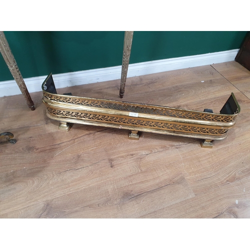 266 - An antique pierced brass Fender, 3ft 5in W, a marble top Wine Table with griffin support on the flut... 