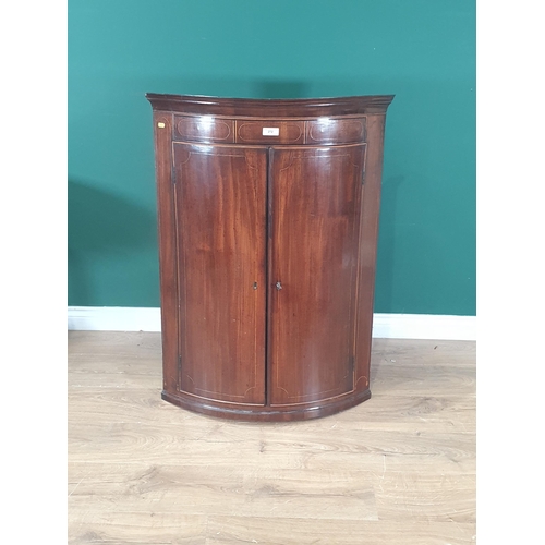 272 - A 19th Century mahogany bow front Hanging Corner Cupboard with satinwood stringing, fitted three fix... 