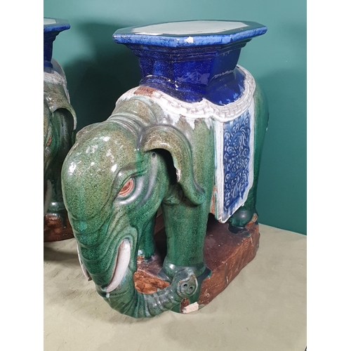 287 - A pair of green and blue glazed pottery Elephant Seats with floral decorated saddles, (the word Chin... 