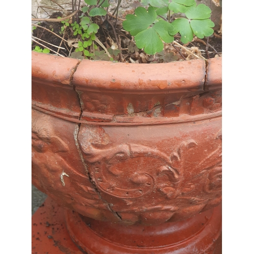 299 - A pair of painted terra cotta Garden Urns with scrolled mask handles, cherub and scrolled leafage de... 