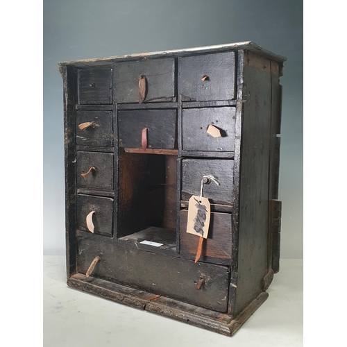 3 - An antique and later painted Spice Cupboard (missing door) with eleven fitted drawers, A/F, 19