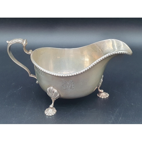 39 - A George V silver Sauce Boat with beaded rims, engraved initials on three shell feet, Birmingham 193... 