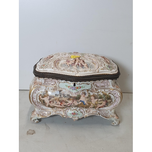 392 - A Continental porcelain Casket with hinged cover moulded chrubs and scrolls, 10in W