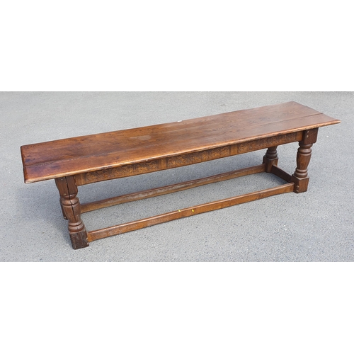 471 - A Large Oak Refectory table with carvings to the side fitted stretchers on all sides, 2ft 7