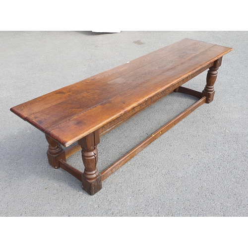 471 - A Large Oak Refectory table with carvings to the side fitted stretchers on all sides, 2ft 7