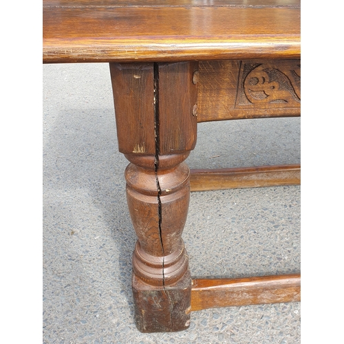 471 - A Large Oak Refectory table with carvings to the side fitted stretchers on all sides, 2ft 7