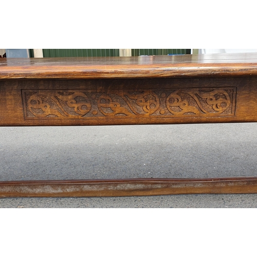 471 - A Large Oak Refectory table with carvings to the side fitted stretchers on all sides, 2ft 7