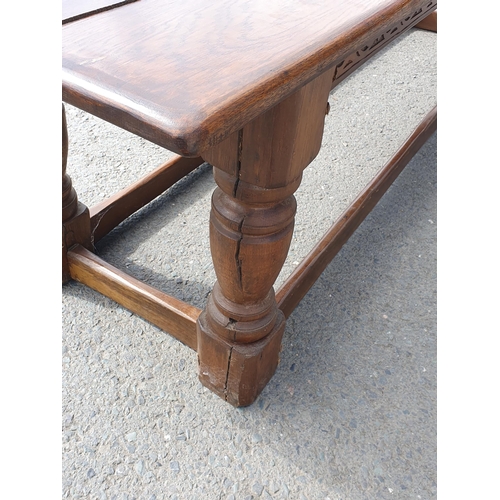 471 - A Large Oak Refectory table with carvings to the side fitted stretchers on all sides, 2ft 7