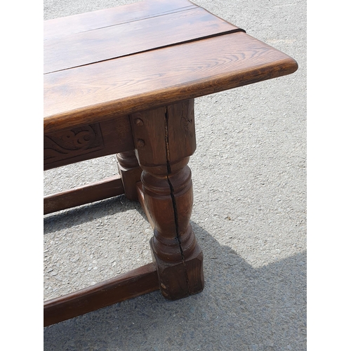 471 - A Large Oak Refectory table with carvings to the side fitted stretchers on all sides, 2ft 7