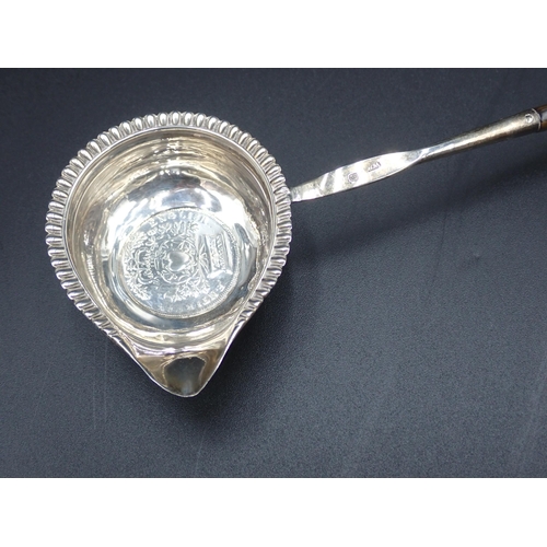 54 - A George IV Punch Ladle with coin inset silver bowl, gadroon rim and spiral whalebone handle, London... 