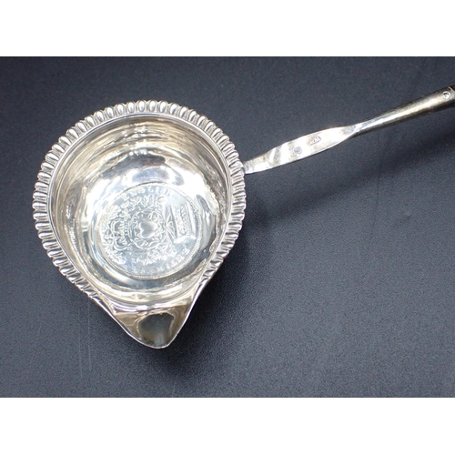 54 - A George IV Punch Ladle with coin inset silver bowl, gadroon rim and spiral whalebone handle, London... 