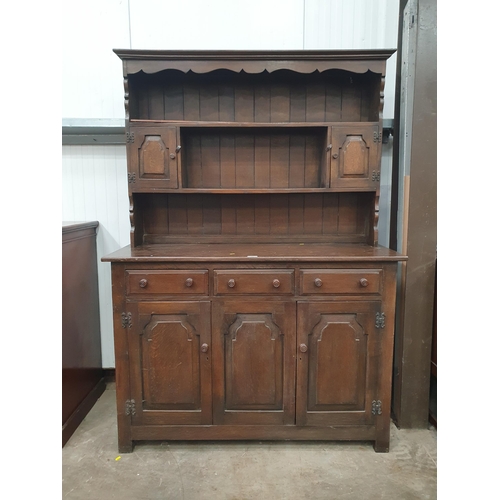 567 - A reproduction oak Dresser and Rack, the rack fitted two small cupboard doors, above three fitted dr... 