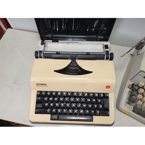 571 - An Alder Gabriele 25 Typewriter c.1968 and an Olympia Monica electric deluxe portable Typewriter